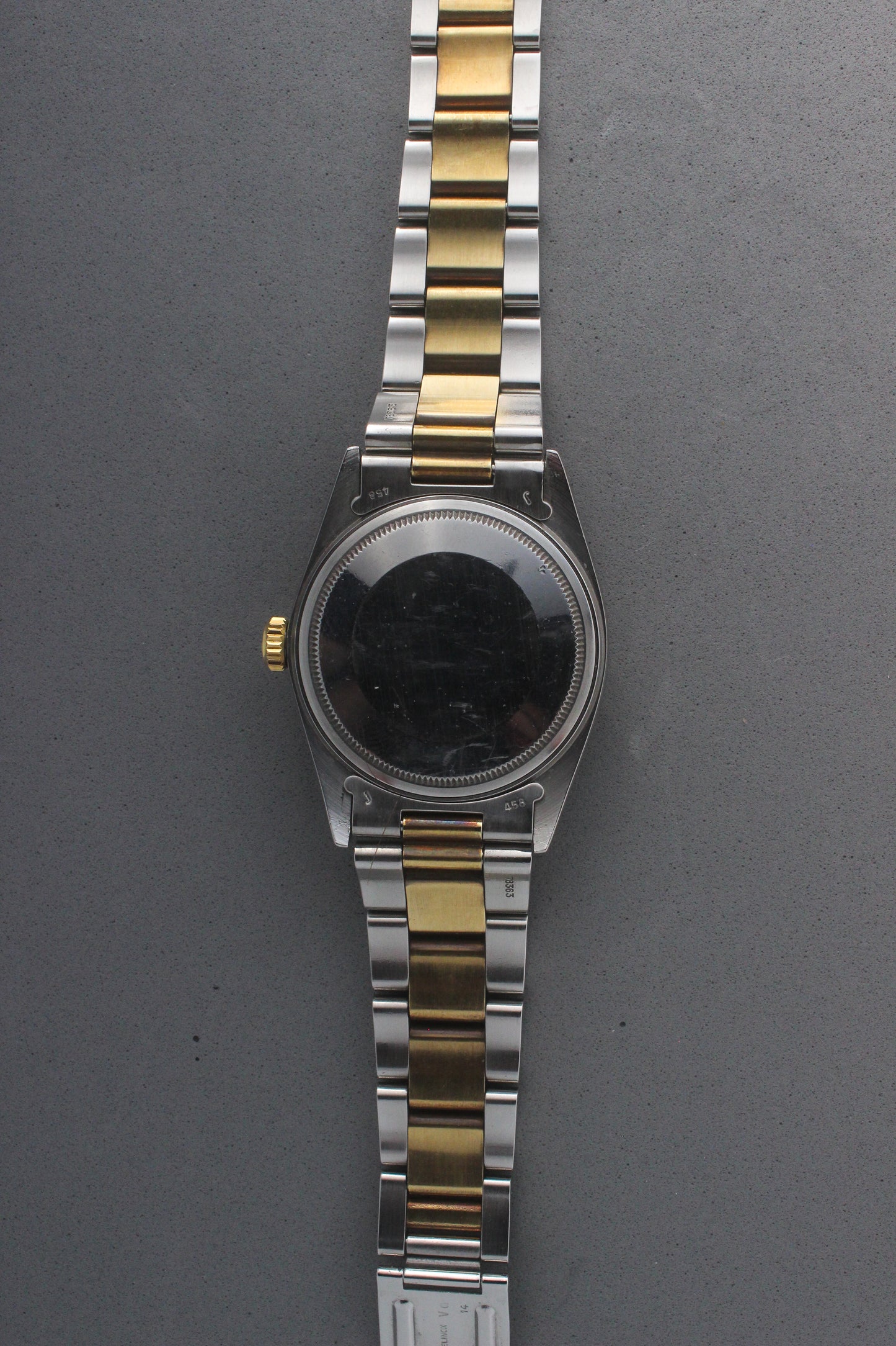 Rear view of the Rolex Datejust reference number 16013, highlighting the stainless steel case back, which is blank and polished, along with the two-tone stainless steel and yellow gold Jubilee bracelet. This image showcases the robust craftsmanship and intricate detailing of the watch, including the solid end links and clasp markings.