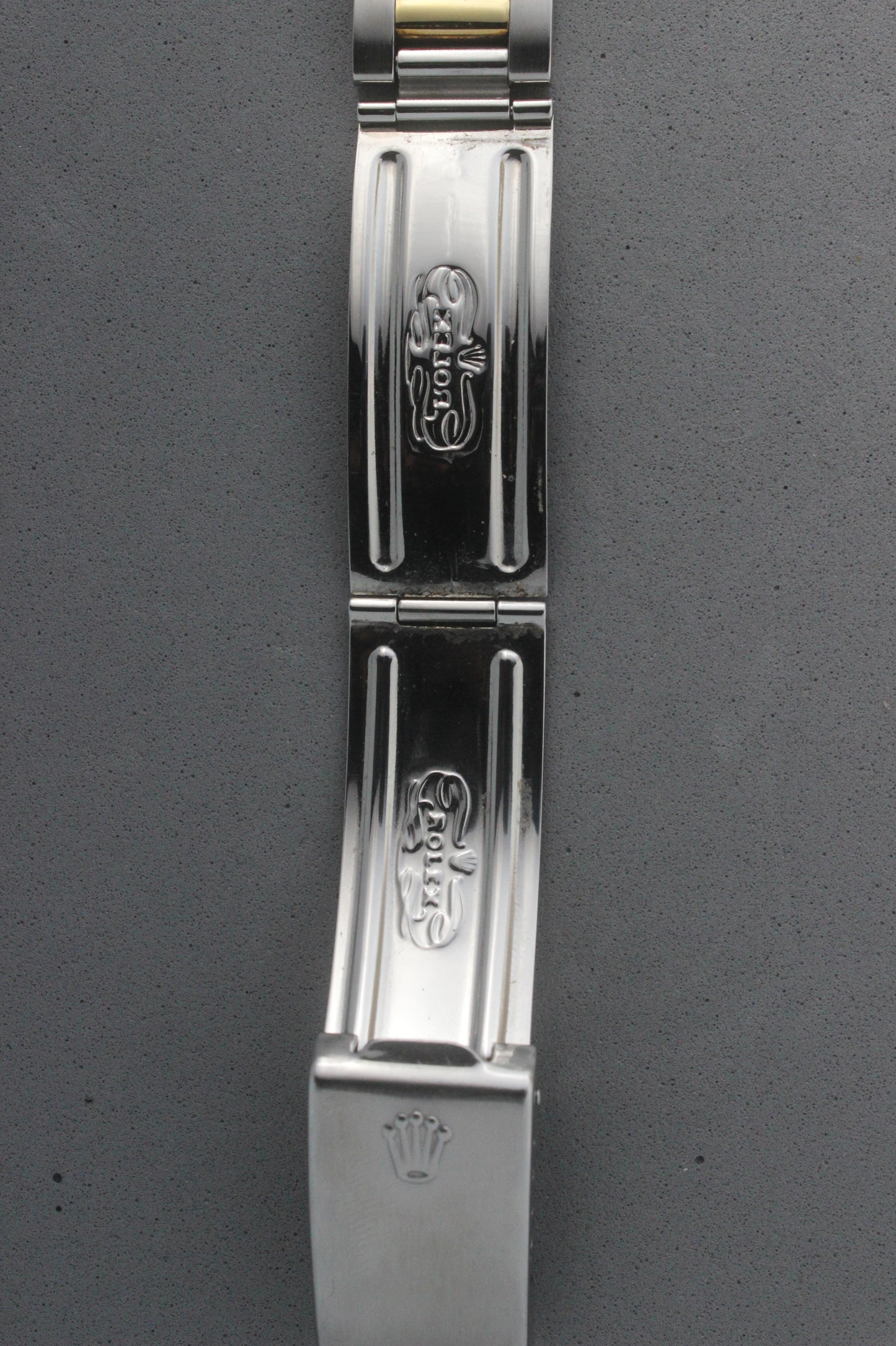Close-up view of the clasp of the Rolex Datejust reference number 16013, featuring the engraved Rolex logo and coronet emblem. The polished stainless steel clasp displays intricate detailing, underscoring the brand’s signature craftsmanship and attention to detail.