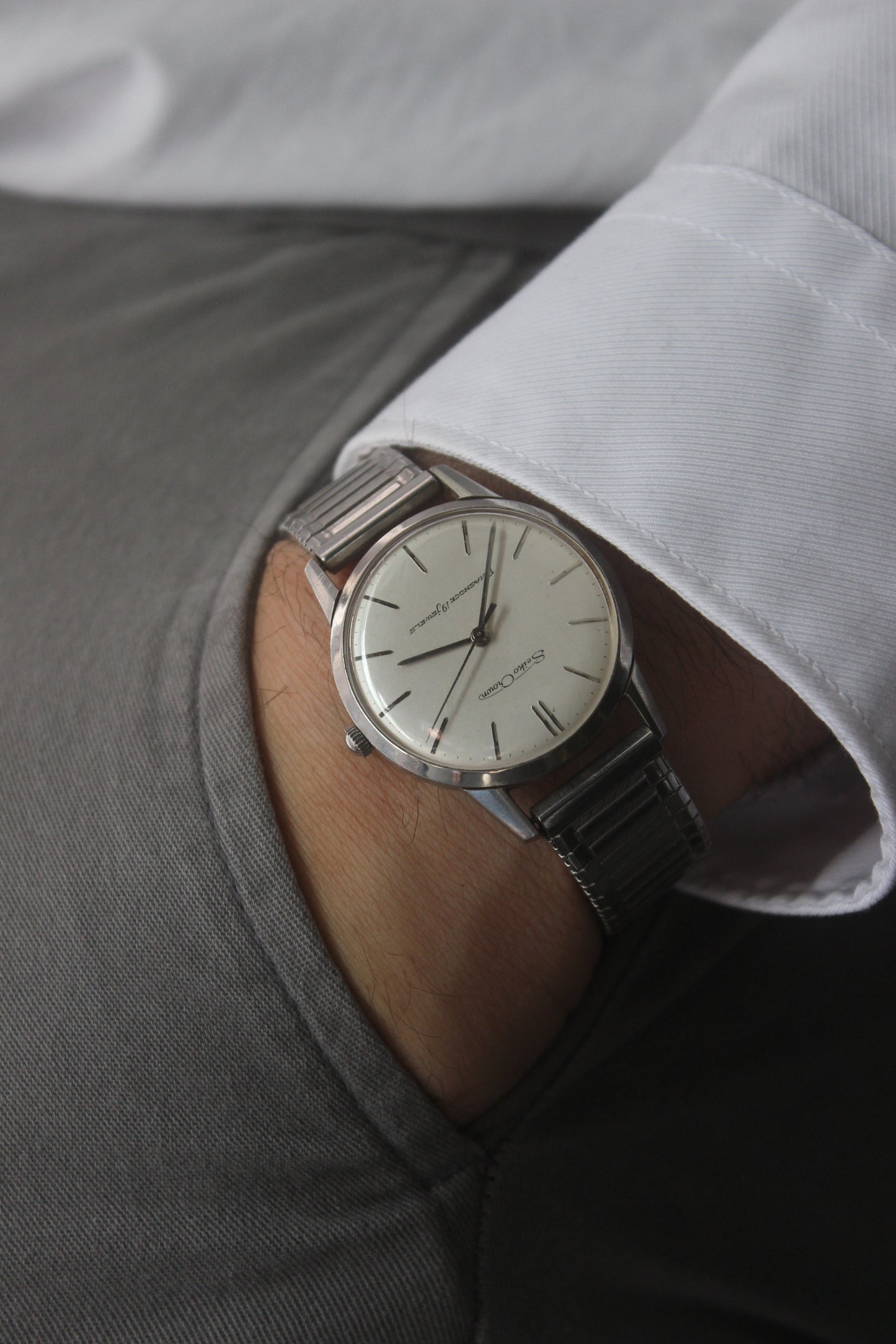 Vintage Seiko Crown 35.5mm stainless steel manual-wind watch from July 1960. Features a flat satin silver lacquered dial with silver indices, a double logo at the 12 and 6 o’clock positions, and slim silver stick hands for hours, minutes, and seconds. The ultra-slim 10mm case is complemented by a stainless steel fixed bezel and a vintage-style stretch bracelet with brushed and polished surfaces. In great condition with minimal signs of wear on the bracelet and crystal. A rare collector's piece.