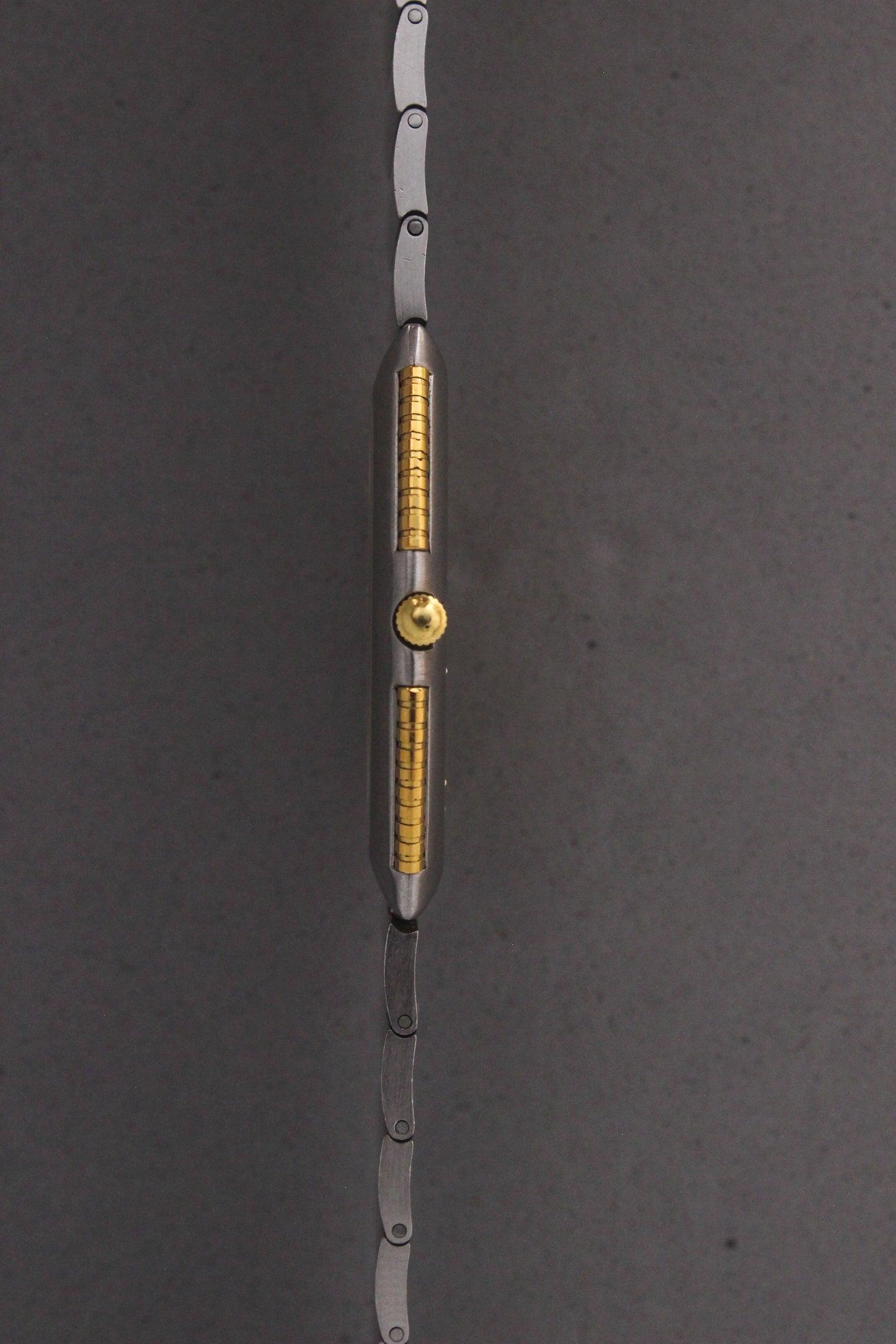 Side View of Universal Genève White Shadow Ref. 617-020
A side profile of the Universal Genève White Shadow Ref. 617-020, showcasing the ultra-slim stainless steel case with gold accents along the sides and a polished crown for a refined finish.