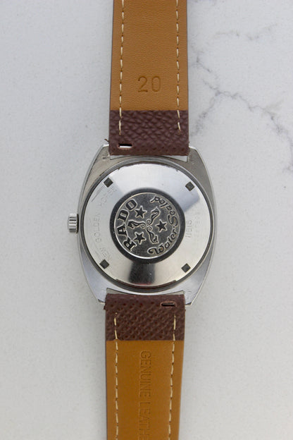Case back of the Rado Golden Horse watch, reference number 11816, showcasing the engraved emblem featuring seahorses, stars, and the ‘Rado’ branding. Surrounding the emblem are the inscriptions ‘New Golden Horse’ and ‘Water Sealed,’ highlighting the timepiece’s durability and classic design.
