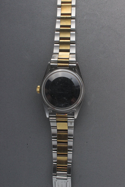 Rear view of the Rolex Datejust reference number 16013, highlighting the stainless steel case back, which is blank and polished, along with the two-tone stainless steel and yellow gold Jubilee bracelet. This image showcases the robust craftsmanship and intricate detailing of the watch, including the solid end links and clasp markings.