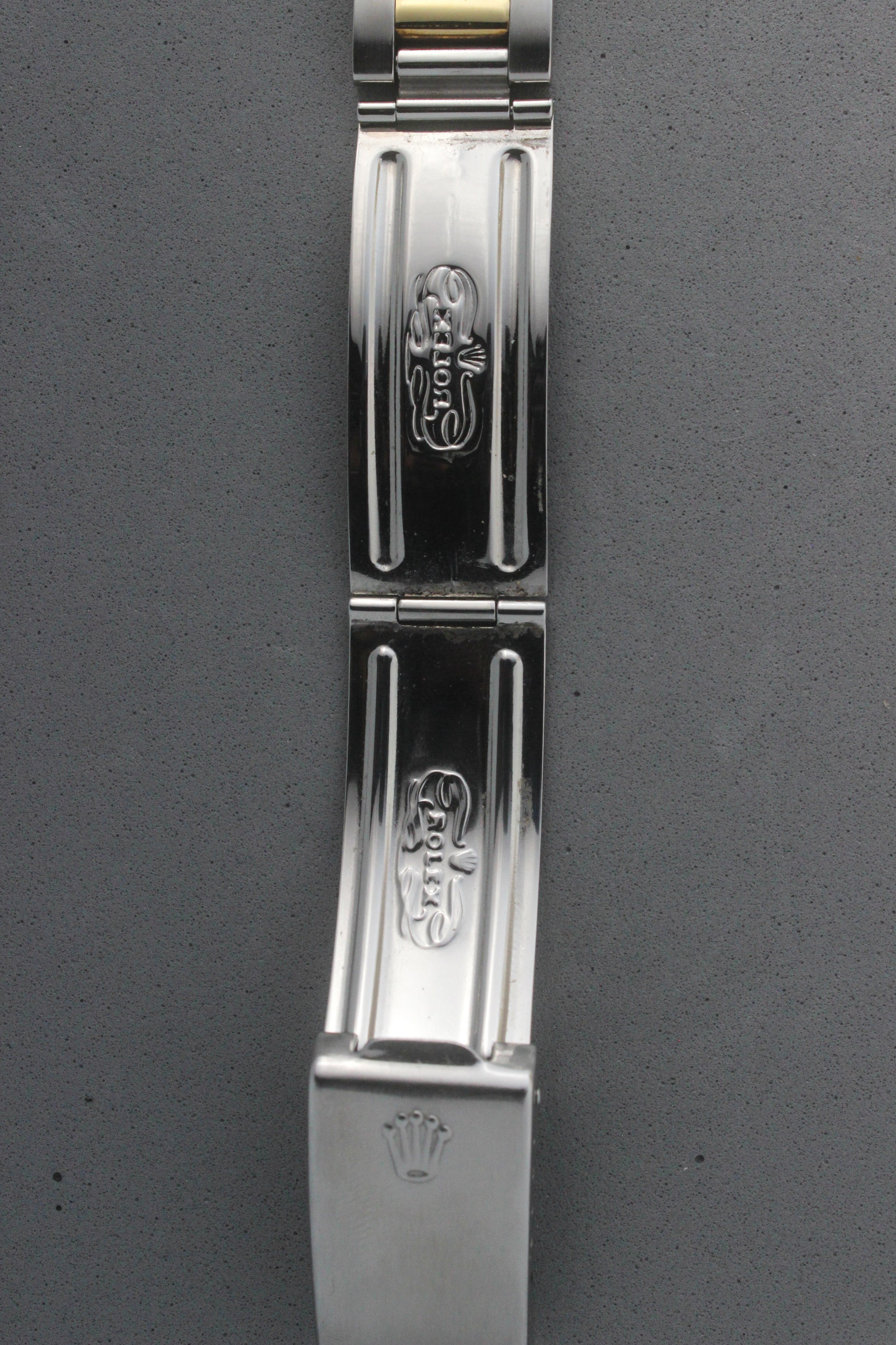 Close-up view of the clasp of the Rolex Datejust reference number 16013, featuring the engraved Rolex logo and coronet emblem. The polished stainless steel clasp displays intricate detailing, underscoring the brand’s signature craftsmanship and attention to detail.