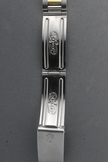 Close-up view of the clasp of the Rolex Datejust reference number 16013, featuring the engraved Rolex logo and coronet emblem. The polished stainless steel clasp displays intricate detailing, underscoring the brand’s signature craftsmanship and attention to detail.