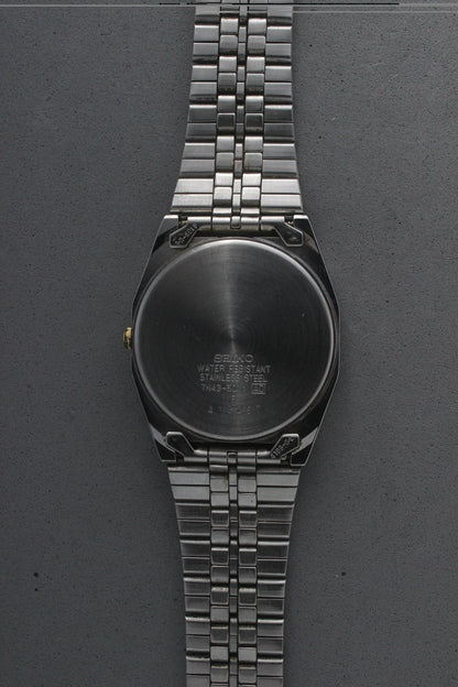 A close-up of the stainless steel case back for the Seiko Quartz 7N43-5011, engraved with model details including "7N43-5011,"
"Water Resistant," and "Made in Japan." The brushed finish highlights the craftsmanship and quality.