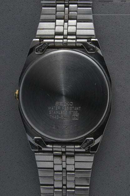 A close-up of the stainless steel case back for the Seiko Quartz 7N43-5011, engraved with model details including "7N43-5011,"
"Water Resistant," and "Made in Japan." The brushed finish highlights the craftsmanship and quality.