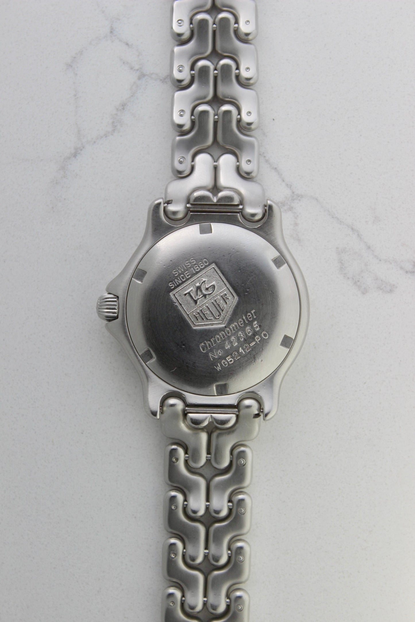 Tag Heuer S/EL Ref. WG5113-P0 stainless steel automatic chronometer watch, 35mm case, 8.6mm thick. Features a two-level dial, TAG Heuer logo, numerals at 6 & 9 o’clock, and a date window. Rotating steel diver bezel, original 6.9" bracelet, and 21-jewel self-winding movement. Includes dive bezel, hours, minutes, seconds & date functions. Rare configuration in great condition with minimal wear. 