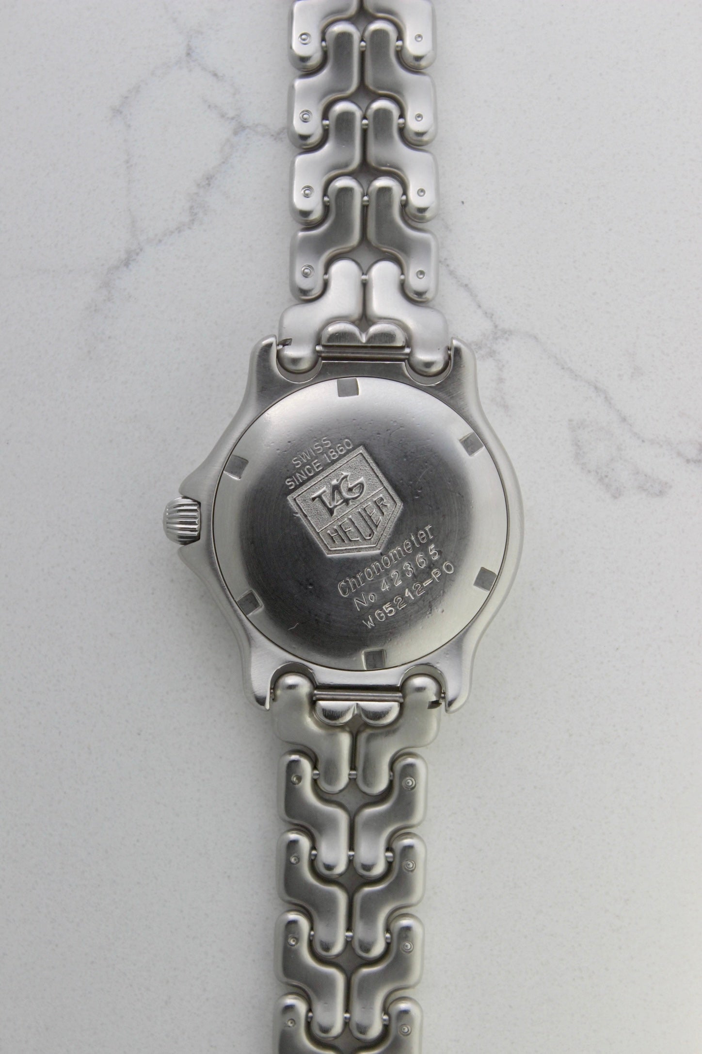 Tag Heuer S/EL Ref. WG5113-P0 stainless steel automatic chronometer watch, 35mm case, 8.6mm thick. Features a two-level dial, TAG Heuer logo, numerals at 6 & 9 o’clock, and a date window. Rotating steel diver bezel, original 6.9" bracelet, and 21-jewel self-winding movement. Includes dive bezel, hours, minutes, seconds & date functions. Rare configuration in great condition with minimal wear. 