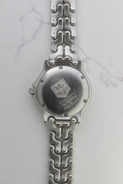 Tag Heuer S/EL Ref. WG5113-P0 stainless steel automatic chronometer watch, 35mm case, 8.6mm thick. Features a two-level dial, TAG Heuer logo, numerals at 6 & 9 o’clock, and a date window. Rotating steel diver bezel, original 6.9" bracelet, and 21-jewel self-winding movement. Includes dive bezel, hours, minutes, seconds & date functions. Rare configuration in great condition with minimal wear. 