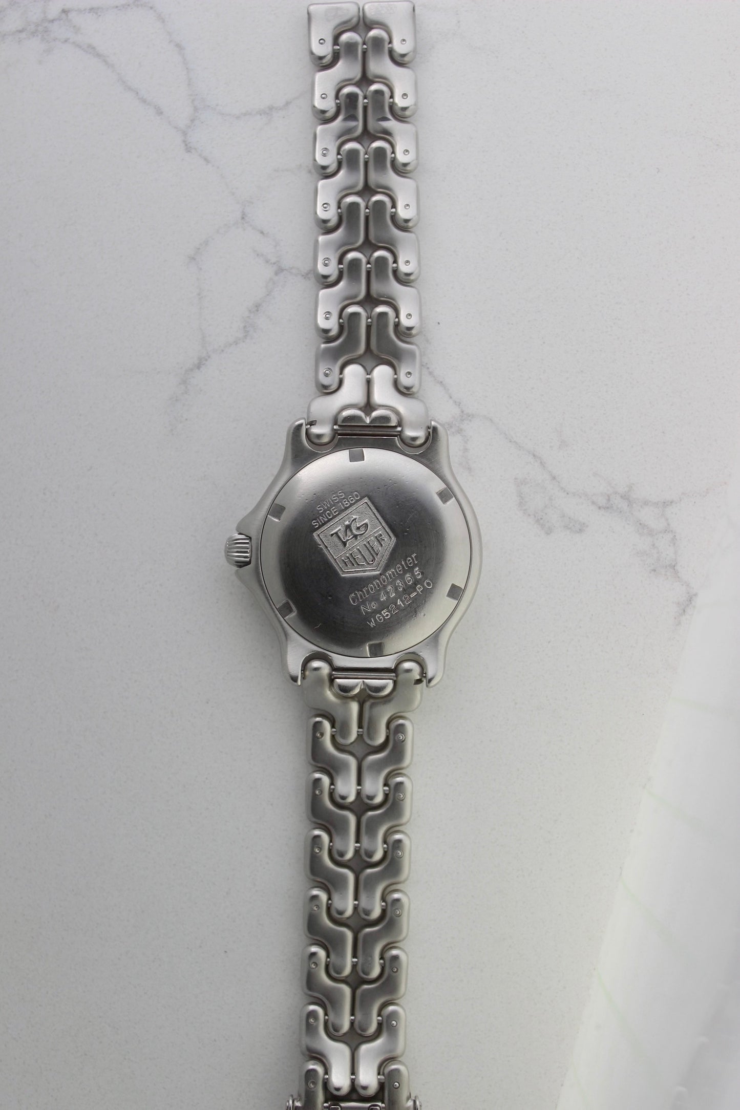 Tag Heuer S/EL Ref. WG5113-P0 stainless steel automatic chronometer watch, 35mm case, 8.6mm thick. Features a two-level dial, TAG Heuer logo, numerals at 6 & 9 o’clock, and a date window. Rotating steel diver bezel, original 6.9" bracelet, and 21-jewel self-winding movement. Includes dive bezel, hours, minutes, seconds & date functions. Rare configuration in great condition with minimal wear. 