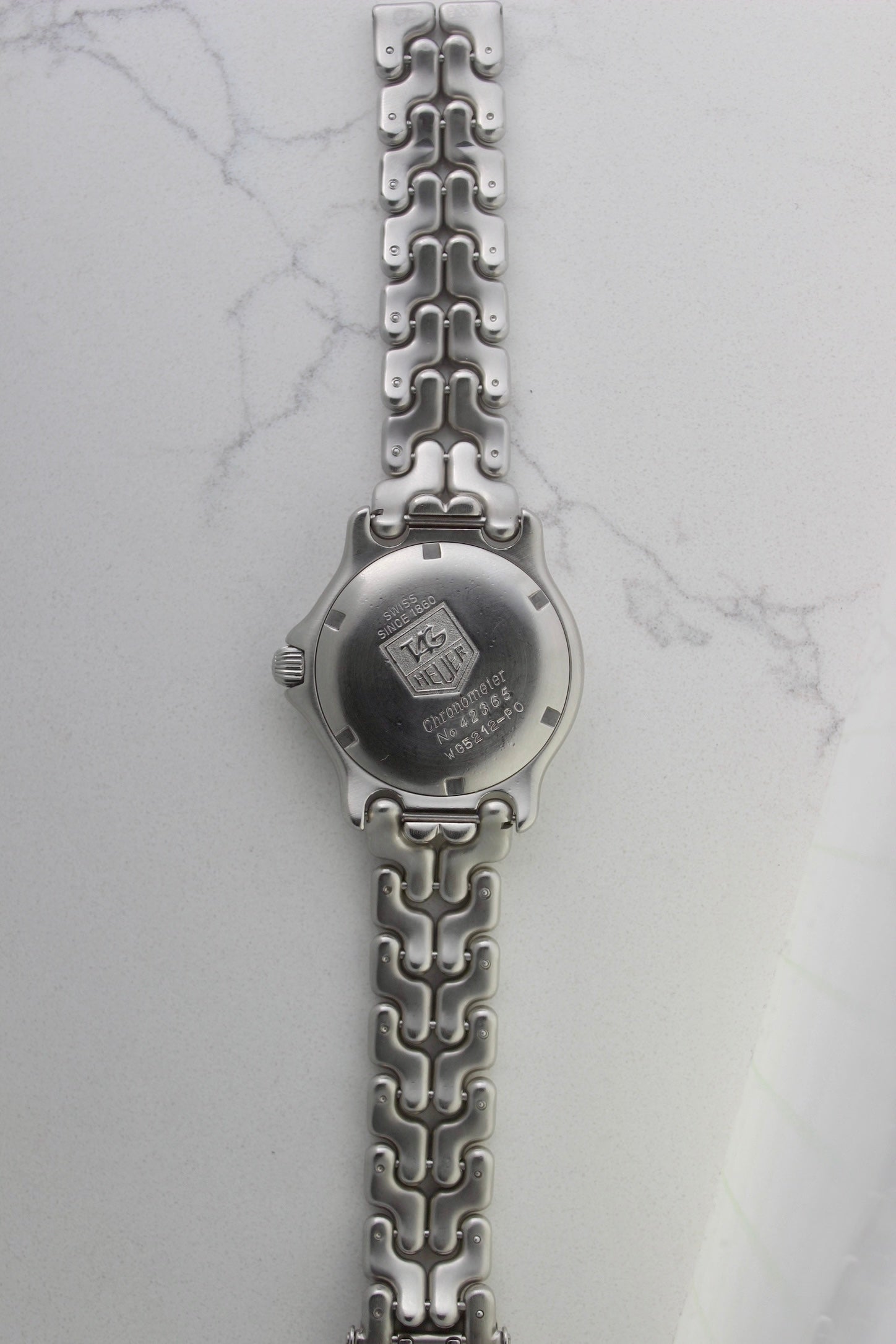 Tag Heuer S/EL Ref. WG5113-P0 stainless steel automatic chronometer watch, 35mm case, 8.6mm thick. Features a two-level dial, TAG Heuer logo, numerals at 6 & 9 o’clock, and a date window. Rotating steel diver bezel, original 6.9" bracelet, and 21-jewel self-winding movement. Includes dive bezel, hours, minutes, seconds & date functions. Rare configuration in great condition with minimal wear. 