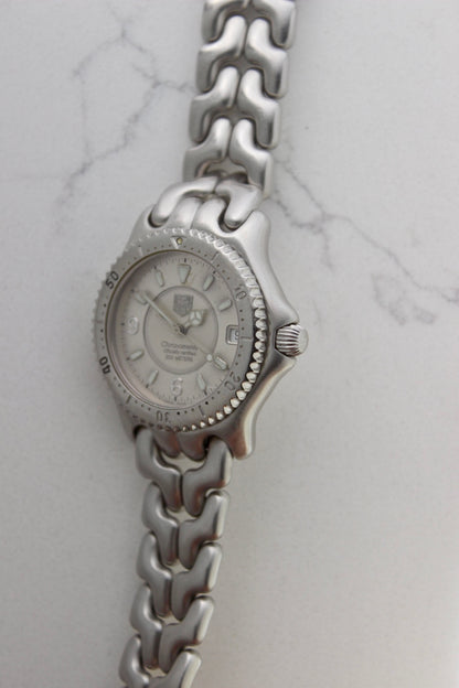 Tag Heuer S/EL Ref. WG5113-P0 stainless steel automatic chronometer watch, 35mm case, 8.6mm thick. Features a two-level dial, TAG Heuer logo, numerals at 6 & 9 o’clock, and a date window. Rotating steel diver bezel, original 6.9" bracelet, and 21-jewel self-winding movement. Includes dive bezel, hours, minutes, seconds & date functions. Rare configuration in great condition with minimal wear. 