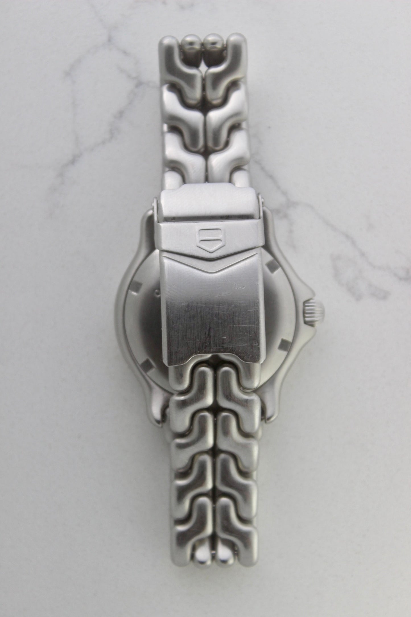 Tag Heuer S/EL Ref. WG5113-P0 stainless steel automatic chronometer watch, 35mm case, 8.6mm thick. Features a two-level dial, TAG Heuer logo, numerals at 6 & 9 o’clock, and a date window. Rotating steel diver bezel, original 6.9" bracelet, and 21-jewel self-winding movement. Includes dive bezel, hours, minutes, seconds & date functions. Rare configuration in great condition with minimal wear. 