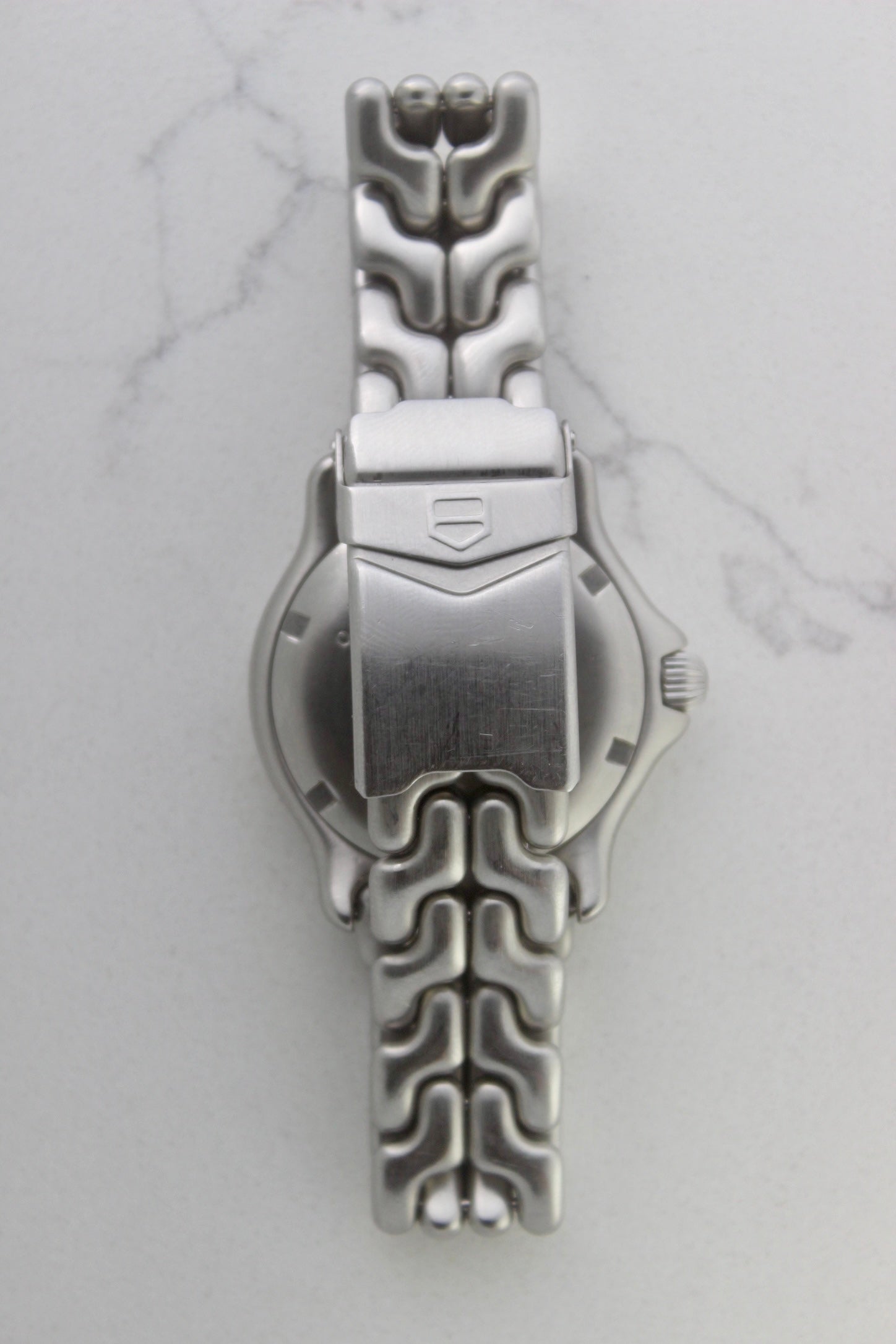 Tag Heuer S/EL Ref. WG5113-P0 stainless steel automatic chronometer watch, 35mm case, 8.6mm thick. Features a two-level dial, TAG Heuer logo, numerals at 6 & 9 o’clock, and a date window. Rotating steel diver bezel, original 6.9" bracelet, and 21-jewel self-winding movement. Includes dive bezel, hours, minutes, seconds & date functions. Rare configuration in great condition with minimal wear. 