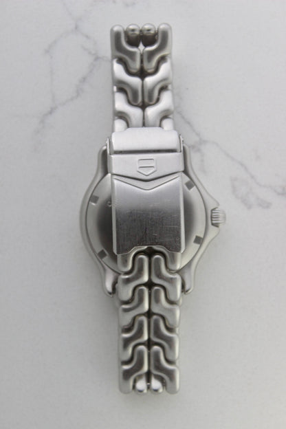Tag Heuer S/EL Ref. WG5113-P0 stainless steel automatic chronometer watch, 35mm case, 8.6mm thick. Features a two-level dial, TAG Heuer logo, numerals at 6 & 9 o’clock, and a date window. Rotating steel diver bezel, original 6.9" bracelet, and 21-jewel self-winding movement. Includes dive bezel, hours, minutes, seconds & date functions. Rare configuration in great condition with minimal wear. 