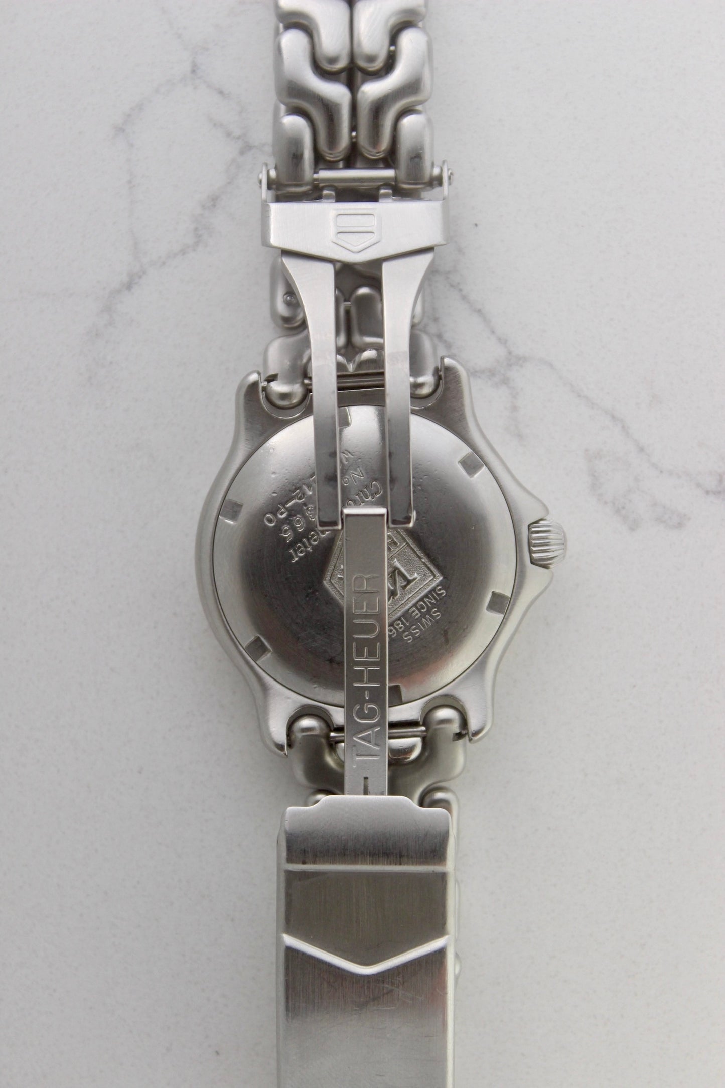 Tag Heuer S/EL Ref. WG5113-P0 stainless steel automatic chronometer watch, 35mm case, 8.6mm thick. Features a two-level dial, TAG Heuer logo, numerals at 6 & 9 o’clock, and a date window. Rotating steel diver bezel, original 6.9" bracelet, and 21-jewel self-winding movement. Includes dive bezel, hours, minutes, seconds & date functions. Rare configuration in great condition with minimal wear. 
