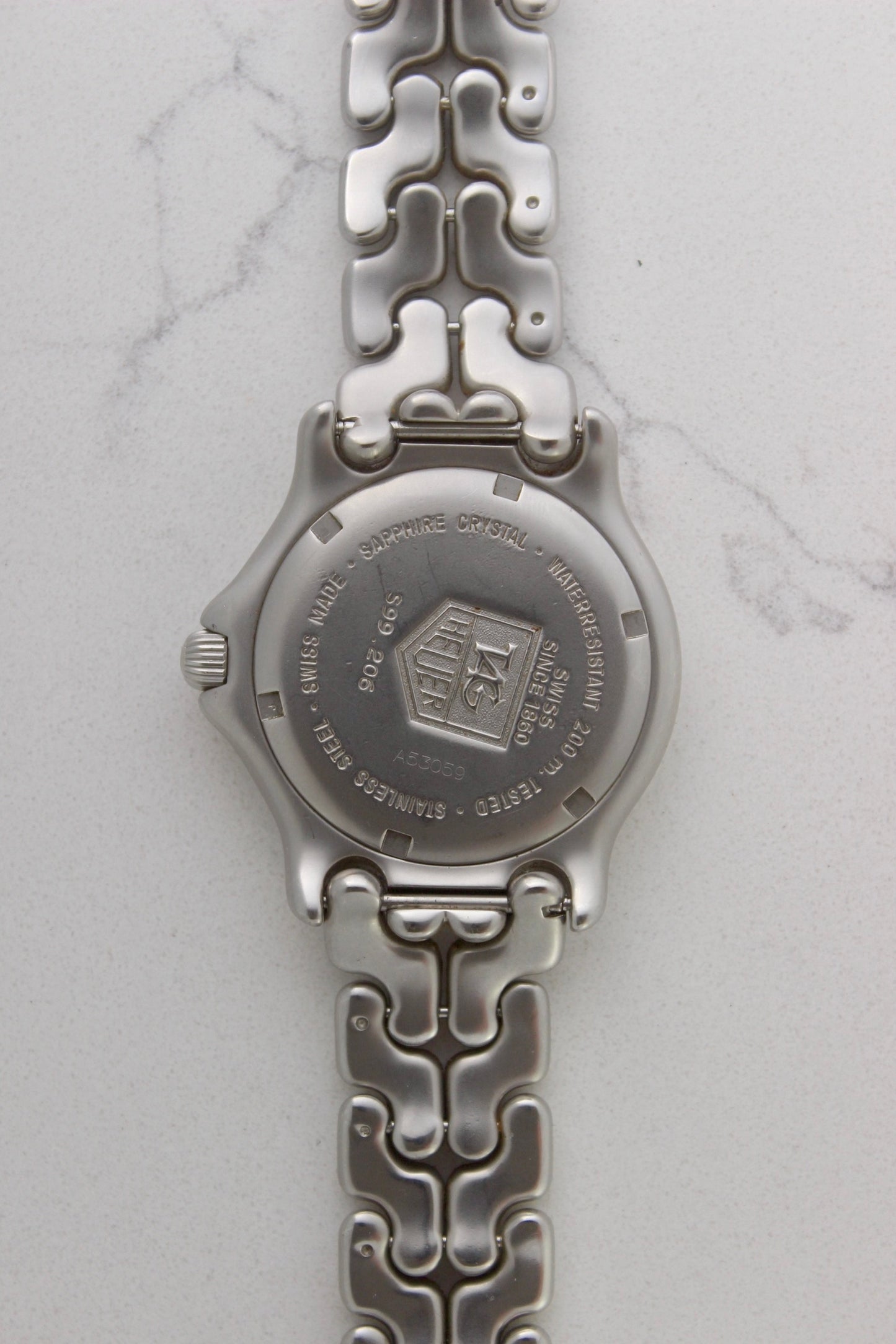 Case back of the Tag Heuer Professional S/EL Ref. S99.206, featuring an engraved Tag Heuer logo, water resistance rating of 200M, and Swiss-made stainless steel construction. Includes sapphire crystal and original bracelet. A rare and collectible vintage timepiece.