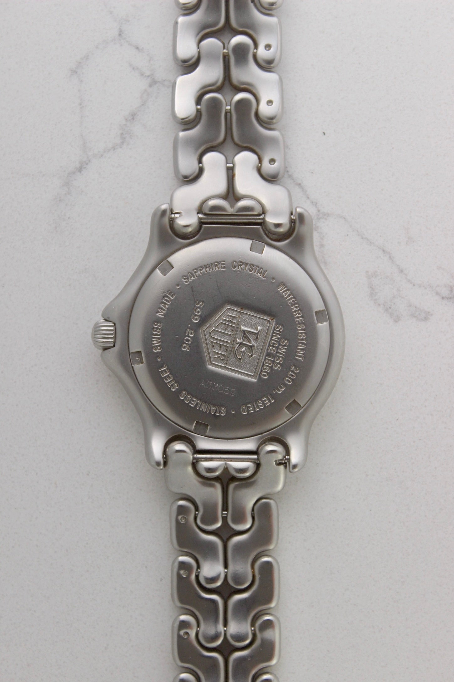 Case back of the Tag Heuer Professional S/EL Ref. S99.206, featuring an engraved Tag Heuer logo, water resistance rating of 200M, and Swiss-made stainless steel construction. Includes sapphire crystal and original bracelet. A rare and collectible vintage timepiece.
