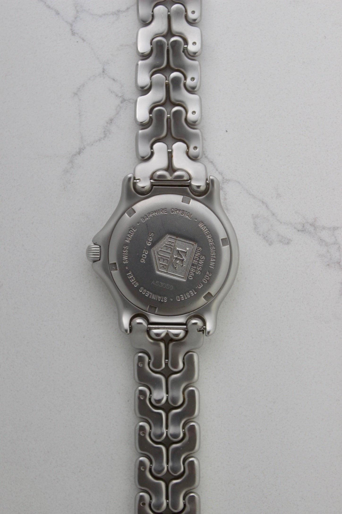 Case back of the Tag Heuer Professional S/EL Ref. S99.206, featuring an engraved Tag Heuer logo, water resistance rating of 200M, and Swiss-made stainless steel construction. Includes sapphire crystal and original bracelet. A rare and collectible vintage timepiece.