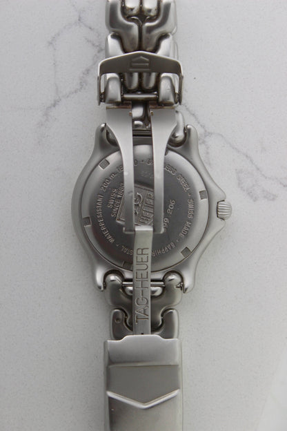 Tag Heuer S/EL Professional watch clasp, featuring the iconic stainless steel bracelet with a secure fold-over clasp engraved with the Tag Heuer shield logo. A durable and stylish vintage timepiece component.