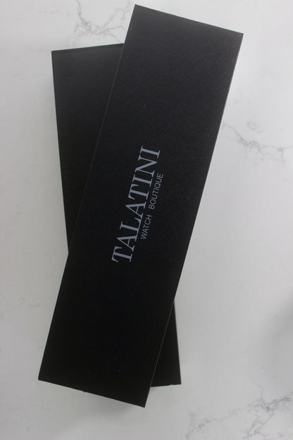 Elegant black packaging box featuring the 'TALATINI Watch Boutique' logo in minimalistic white font, showing a premium and sophisticated brand identity. 