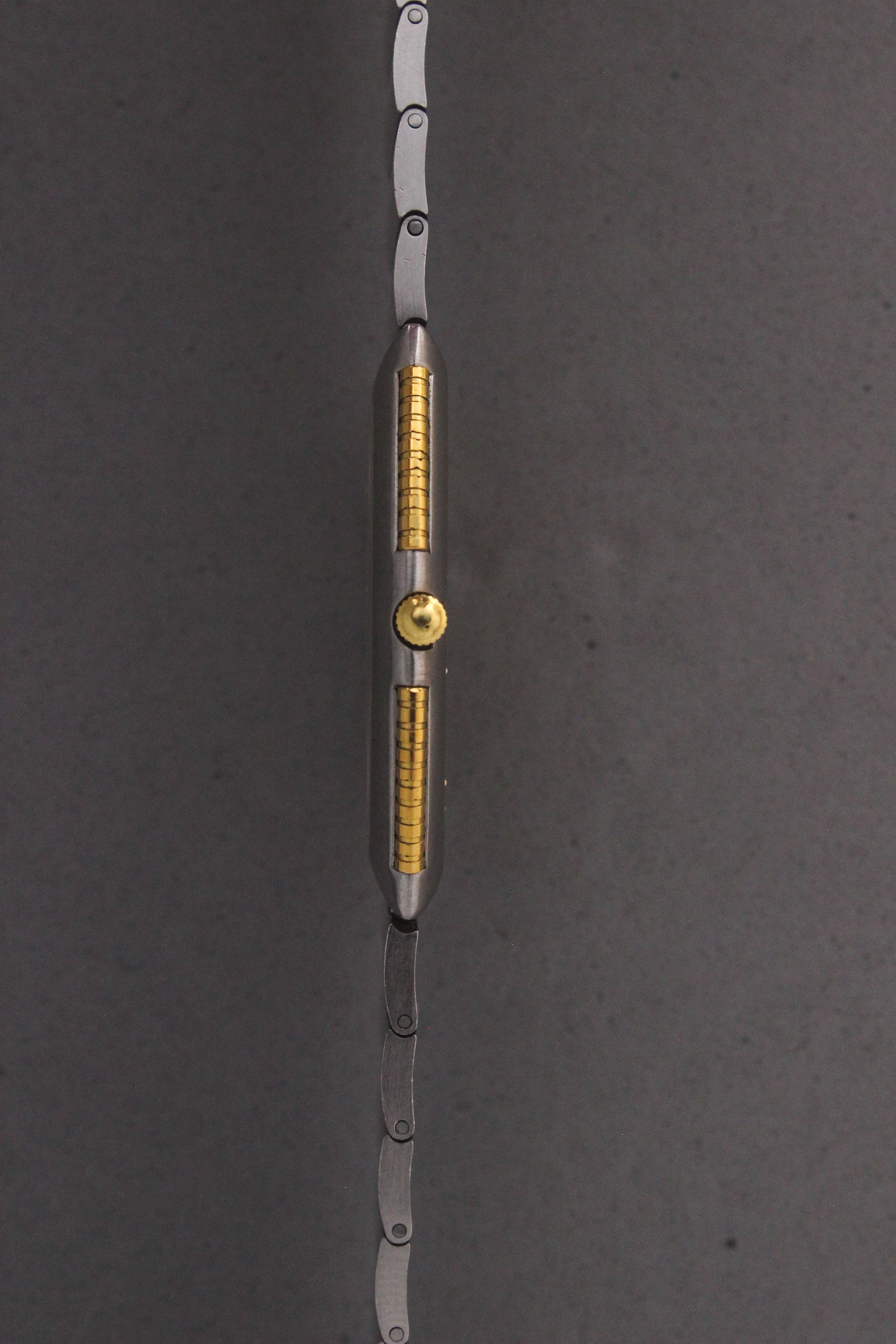 Side View of Universal Genève White Shadow Ref. 617-020
A side profile of the Universal Genève White Shadow Ref. 617-020, showcasing the ultra-slim stainless steel case with gold accents along the sides and a polished crown for a refined finish.