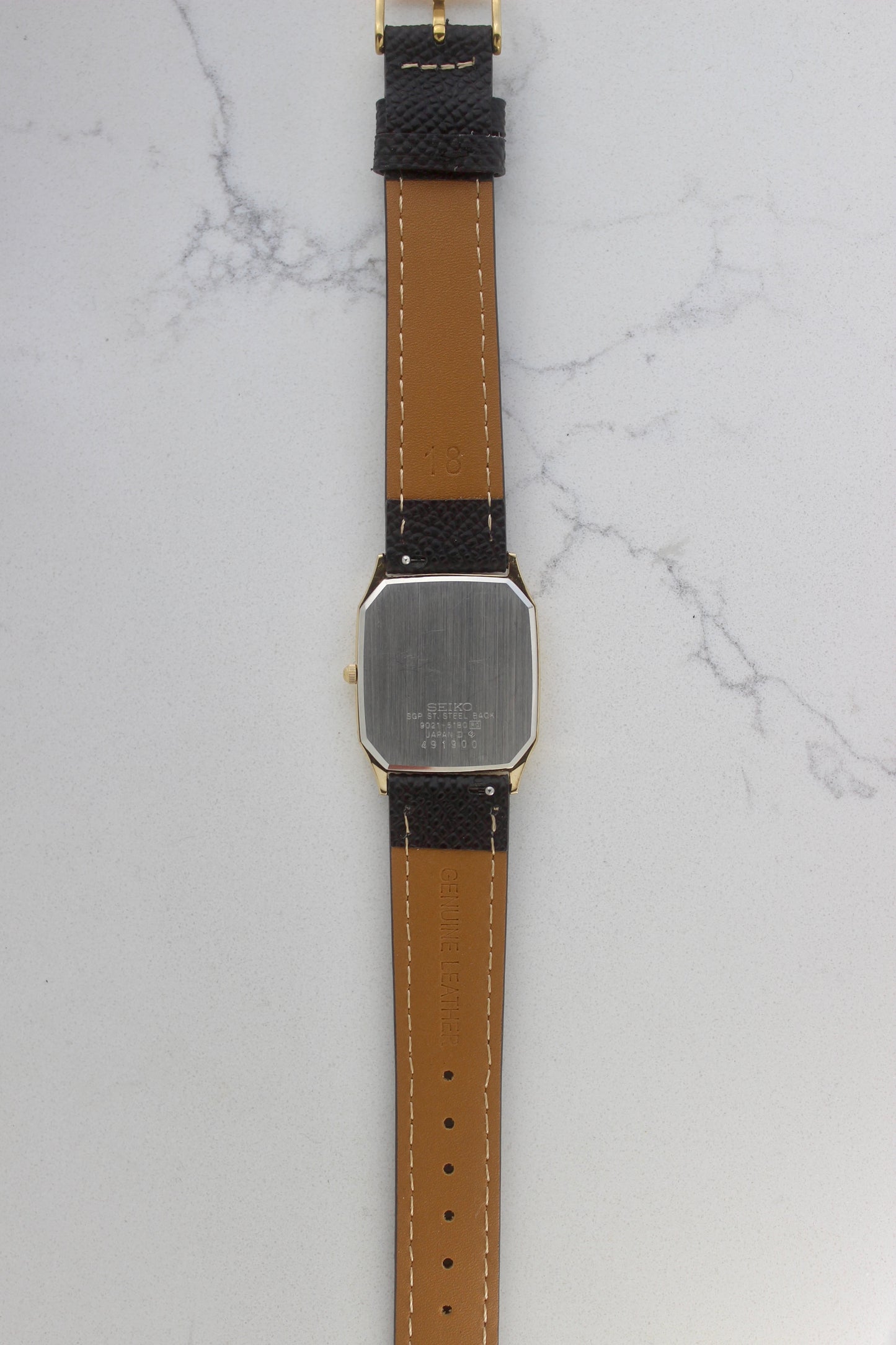 The stainless steel back of the Seiko Chariot 9021-5180 displays the engraved model number, "9021-5180," along with "SGP ST.
Steel Back" and "Made in Japan." The brushed finish highlights its premium quality and craftsmanship.